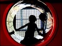 Photo of a child playing in a play place tunnel